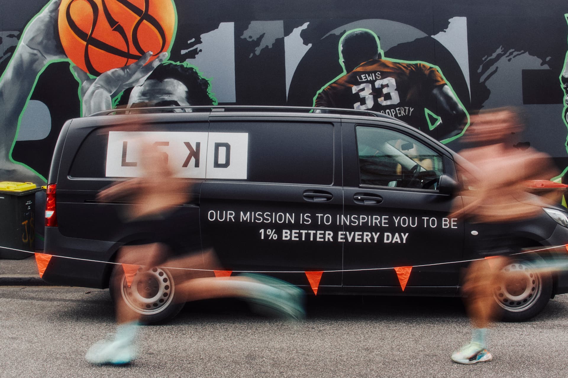 Runners flashing past the LSKD van on the block
